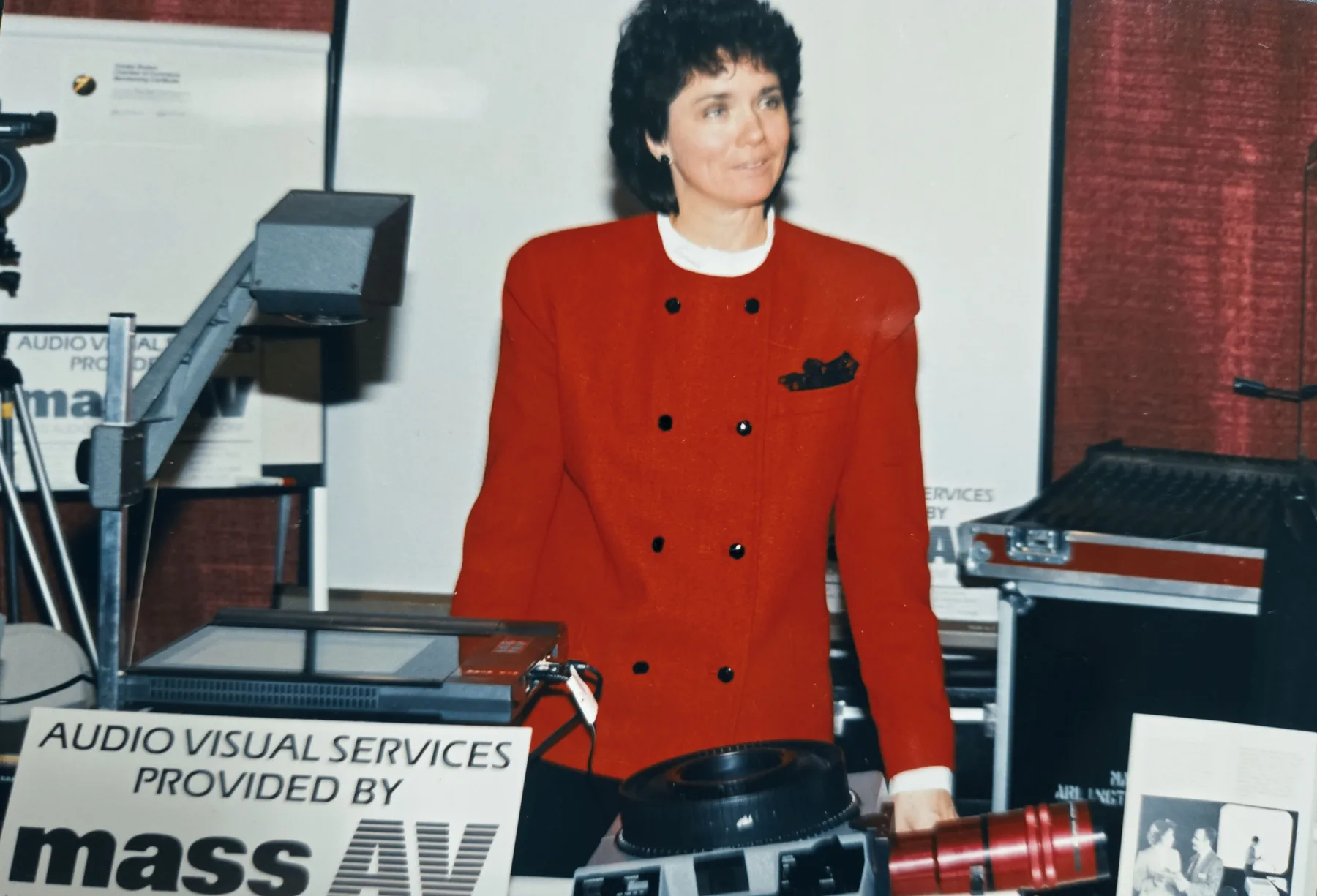 Vintage photo of a MASS AV team member at an audiovisual trade show booth in the company's early years
