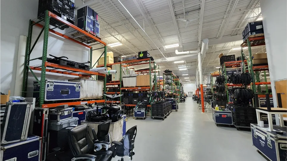 Road cases and production equipment on warehouse racking at the Stagedge facility