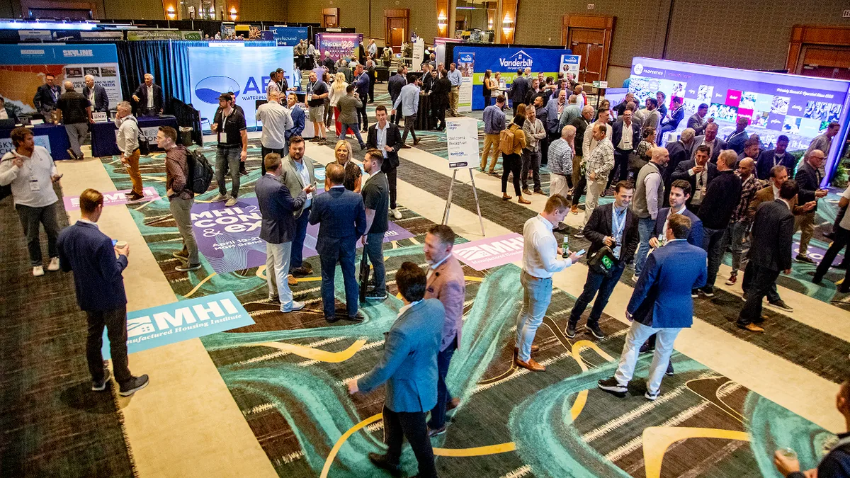 Attendees networking on a conference expo floor between sessions