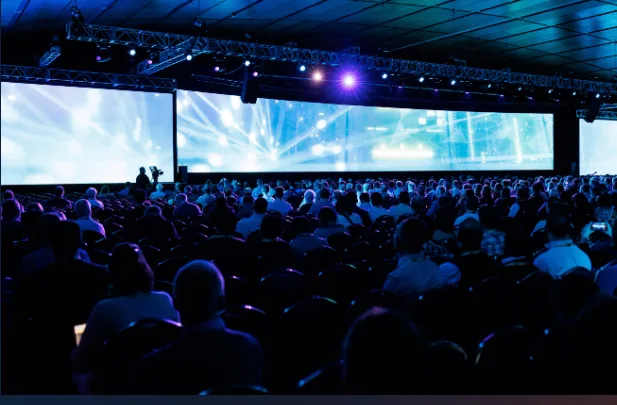 In-room audience and remote participants connected during a hybrid event
