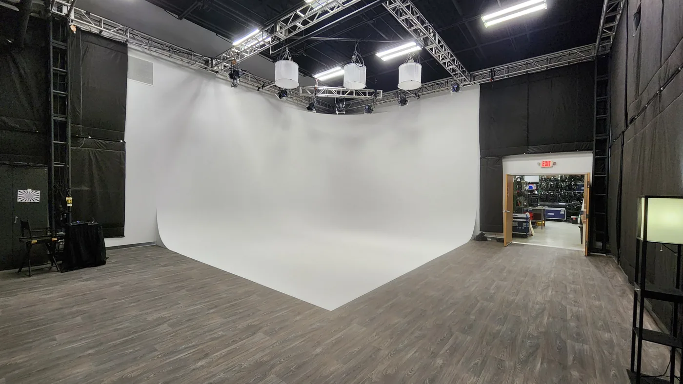 White cyclorama wall and overhead lighting truss in the Stagedge video production studio in Tewksbury
