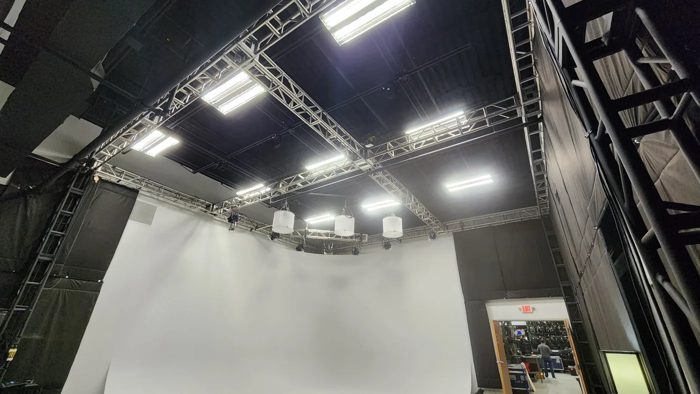 Overhead lighting grid with 17-foot trussing and fixtures above the Stagedge studio cyclorama