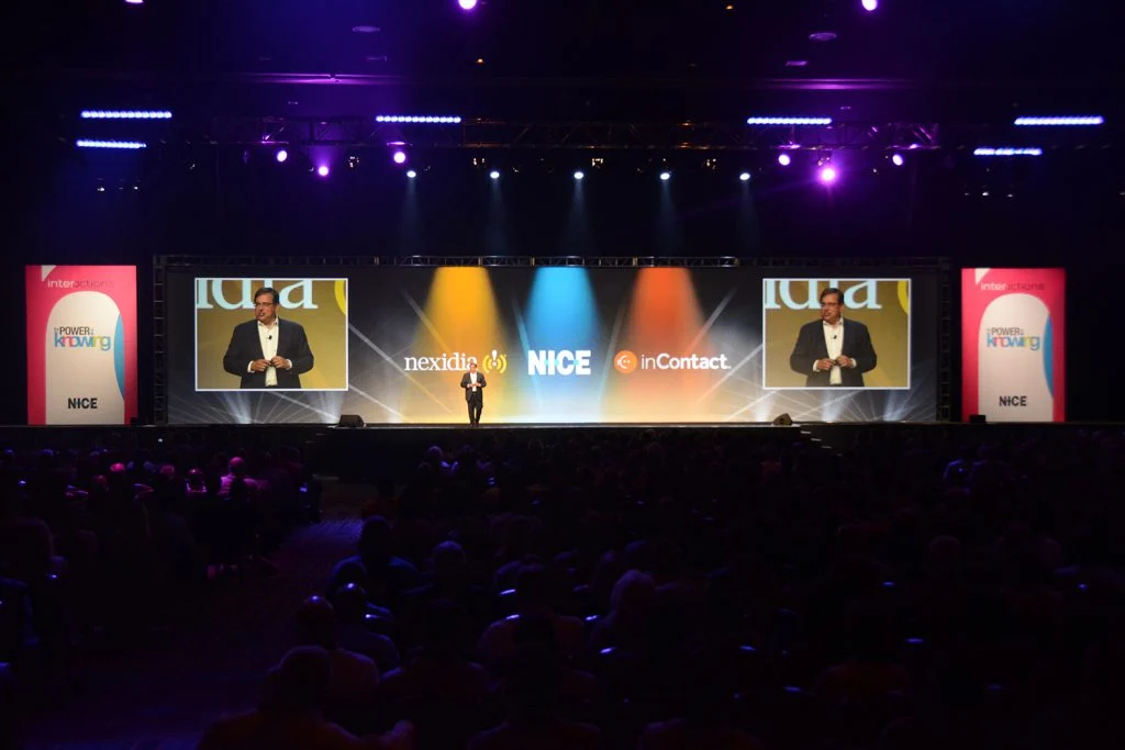Main stage and projection screens at the NICE annual user conference