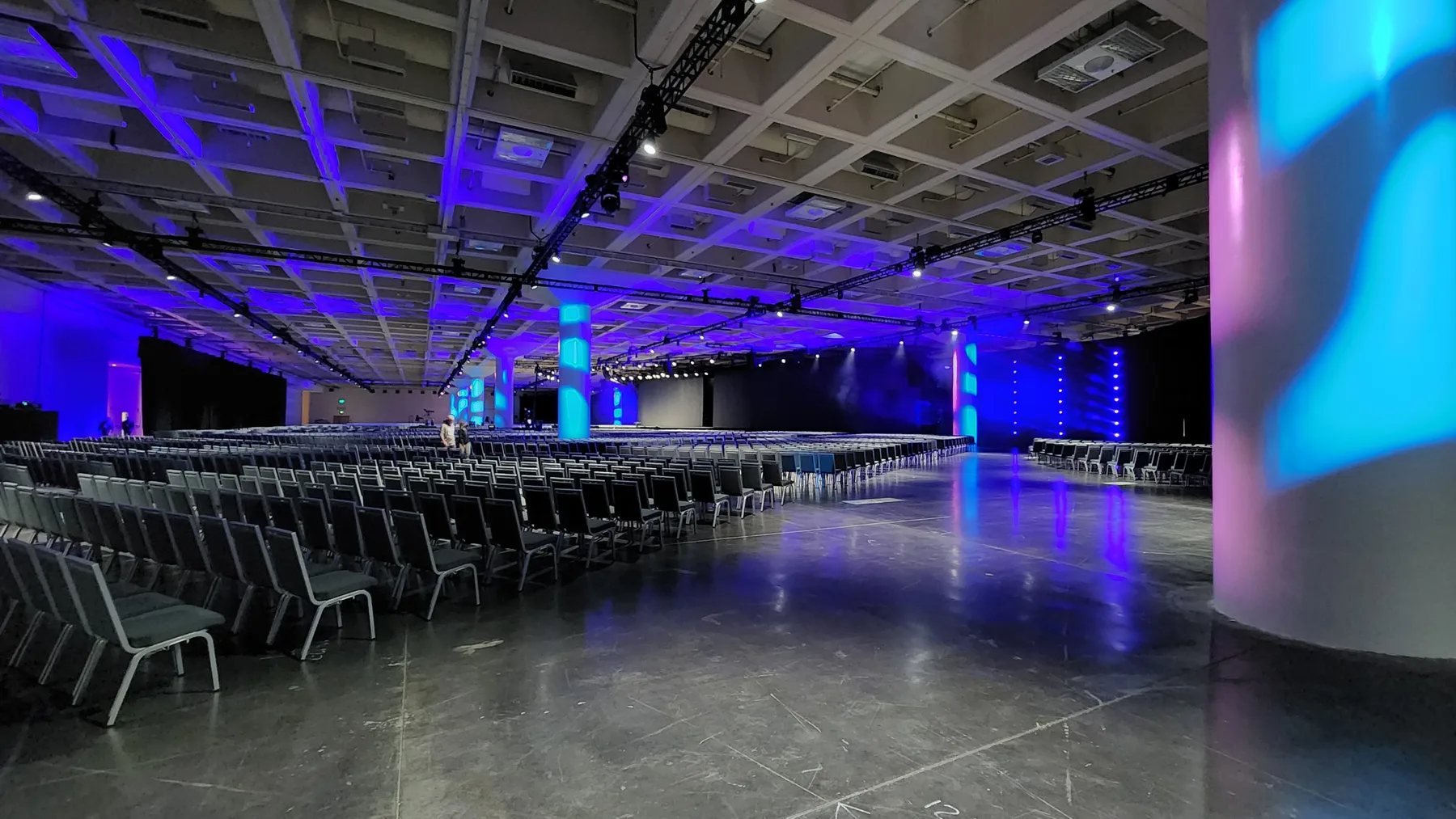 Conference stage production and attendees at VMware Explore